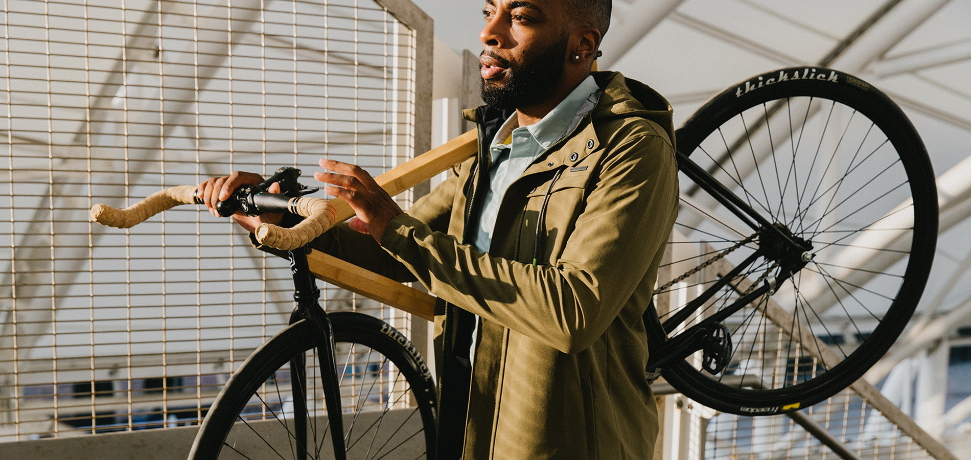 Commuter Cyclist Carrying Bike on Shoulder